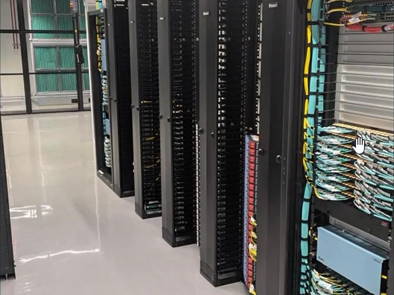 Data-centre aisle with cabinets and overhead cable trays