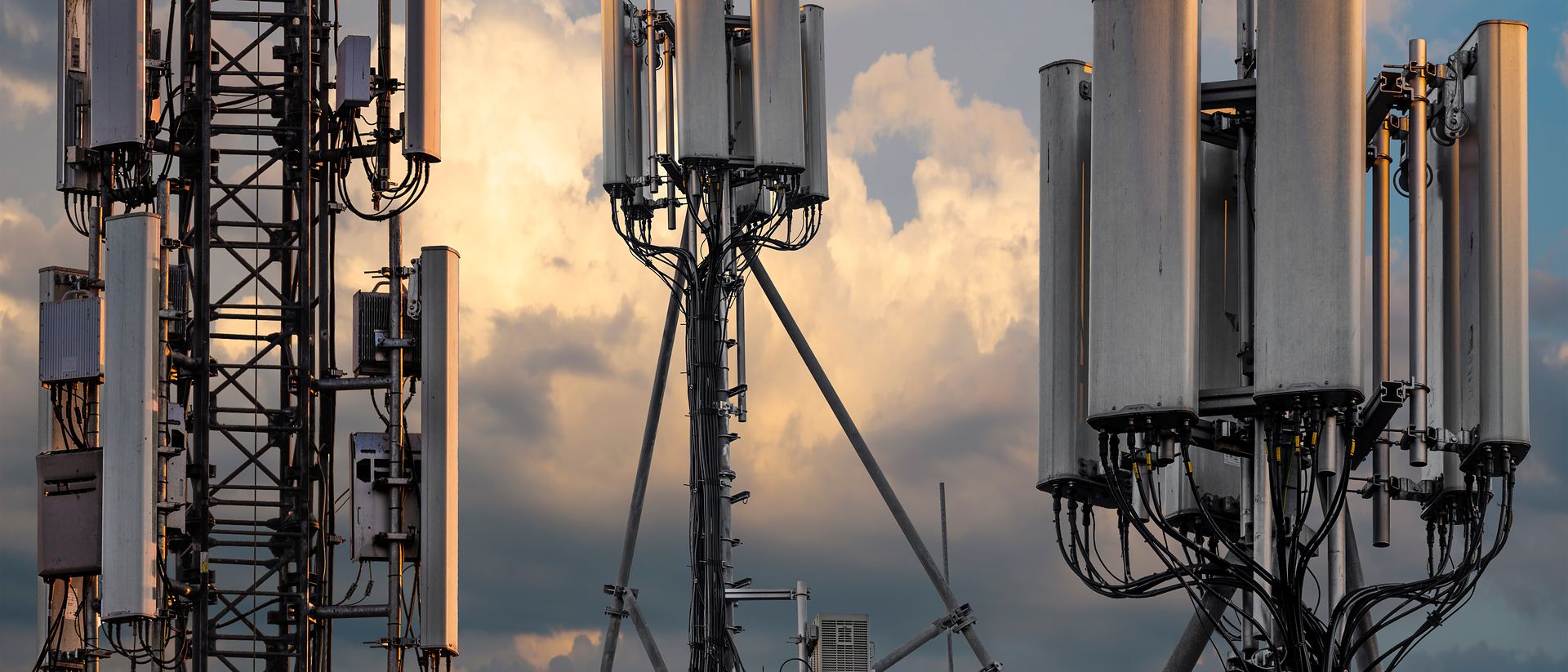Telecommunication antennas against an evening sky