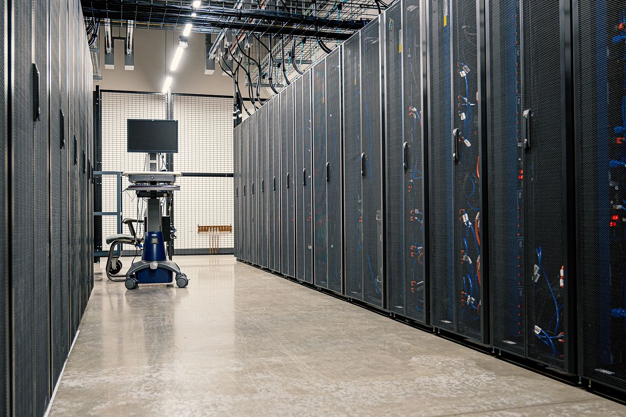 Data-centre aisle with rows of equipment cabinets
