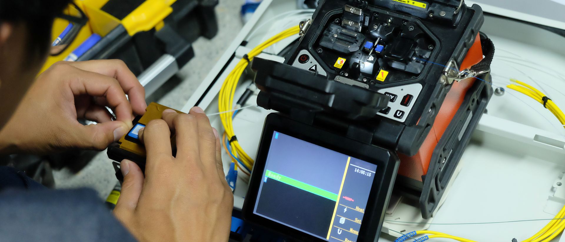 Technician working with a fibre fusion splicer