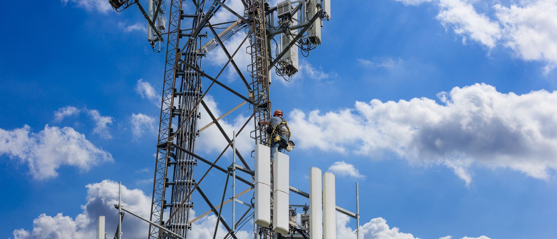 Telecommunication tower with antennas against a blue sky