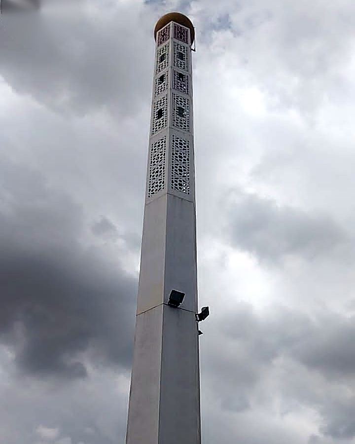 White minaret-style monopole seen from below