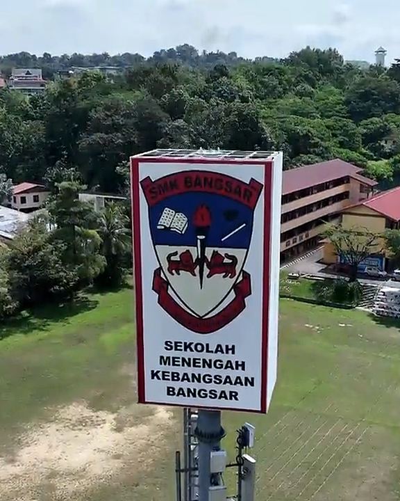 Aerial view of a signboard-style concealed structure on a school field